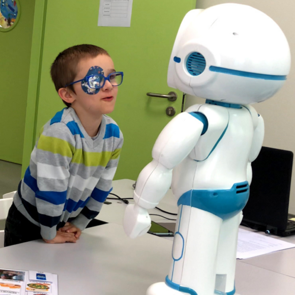 QTrobot interacting with child in a school setting