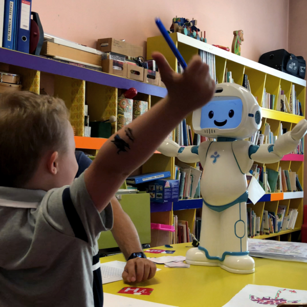 QTrobot interacting with child in a school setting