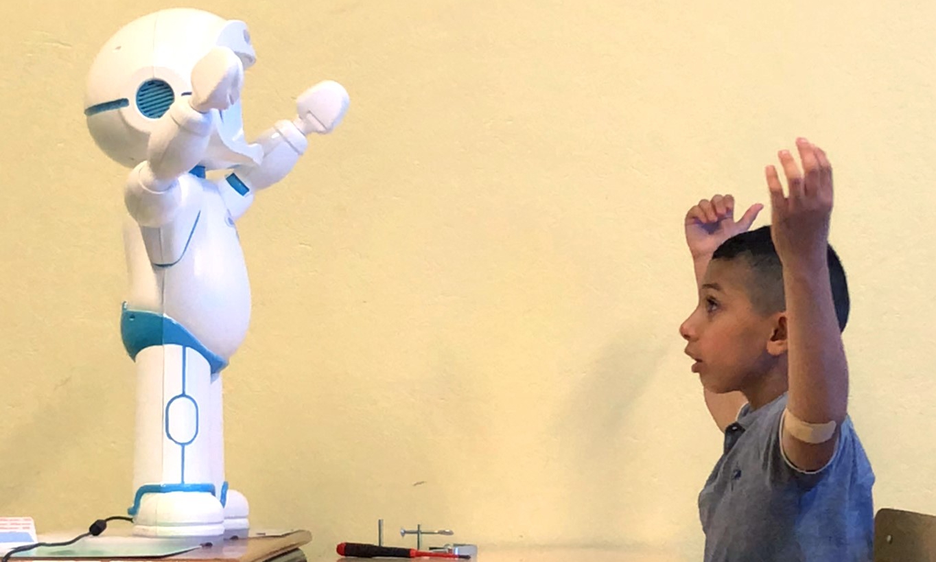 Robot mediating teaching imitation to students with autism