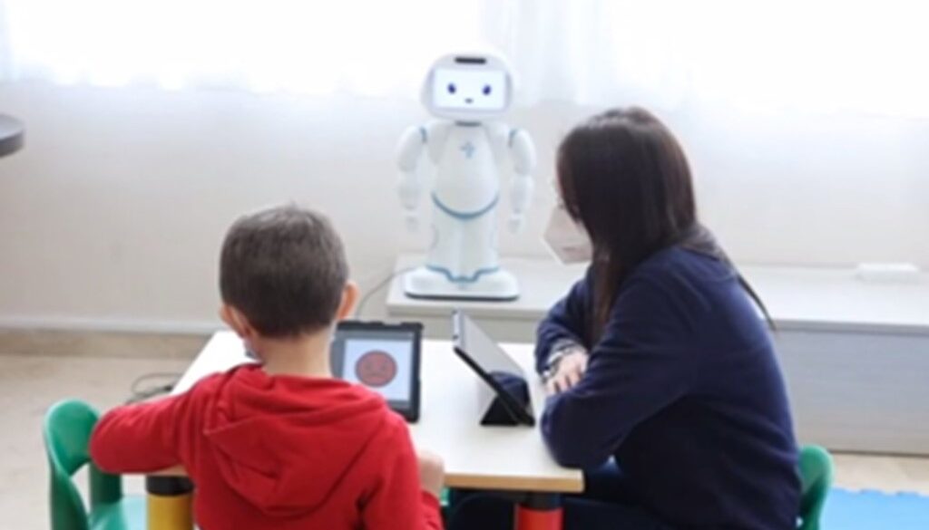 Exploring behavioral and physiological interactions in a group-based emotional skill social robotic training for autism spectrum disorders
