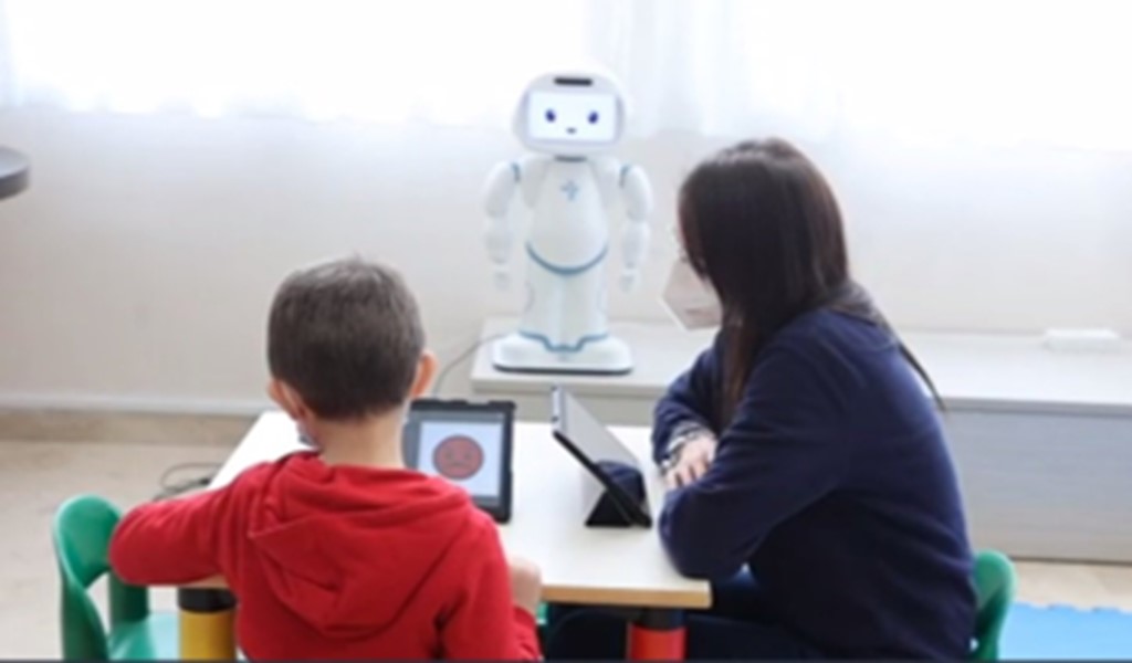 Exploring behavioral and physiological interactions in a group-based emotional skill social robotic training for autism spectrum disorders